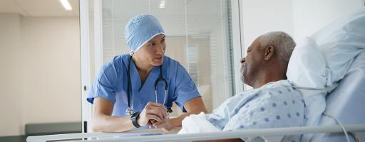 doctor with patient in hospital bed