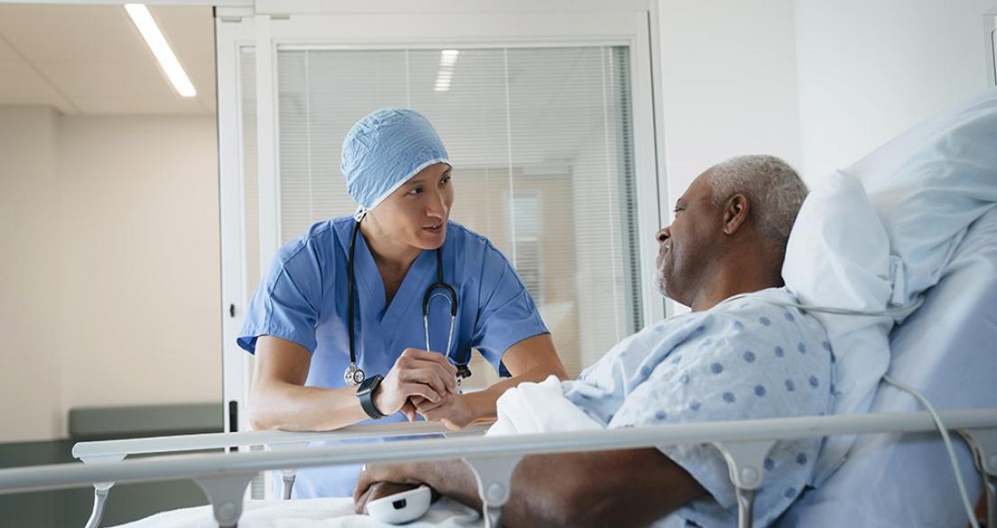 doctor with patient in hospital bed